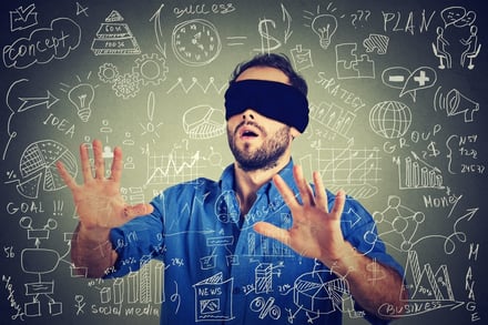 blindfolded man with blackboard